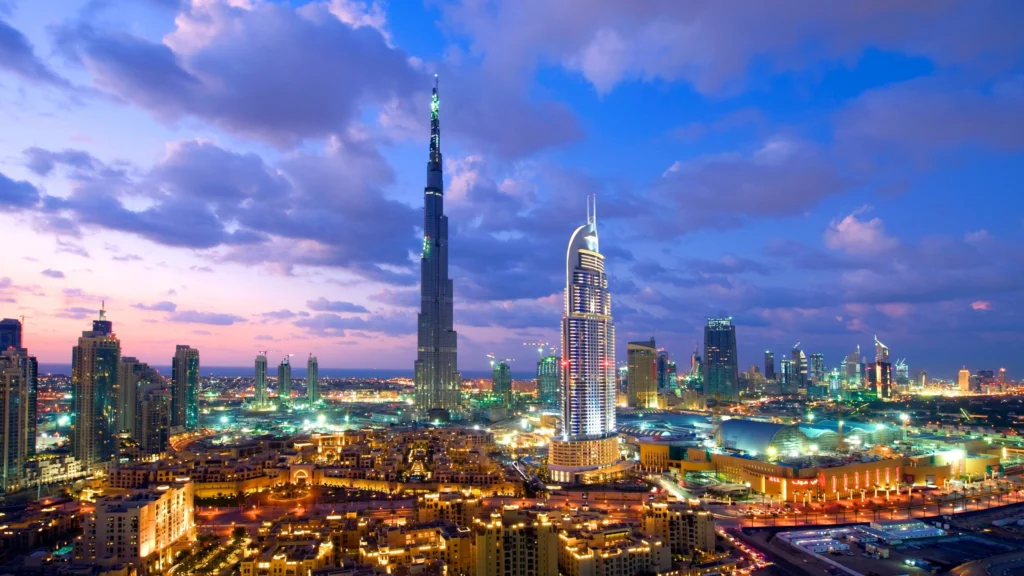 Modern Dubai skyline with Burj Khalifa and rising sun over new developments